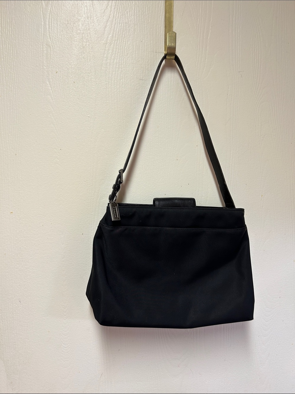 Elegant Black Coach Shoulder Bag with Minimal Hardware